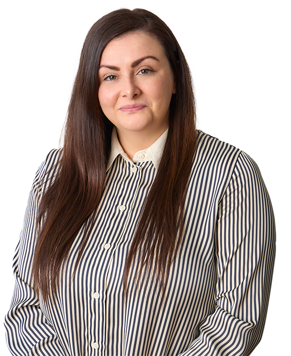 Professional headshot of Rosarii Doyle, she has long, straight brown hair. She is wearing a vertically striped black-and-white button-down shirt with a collar. She is smiling gently.